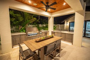 Custom Outdoor Kitchen Dining Area with Hestan Gas Grill Side Burner Fridge and Ice Maker Installed in Tampa Florida WEB