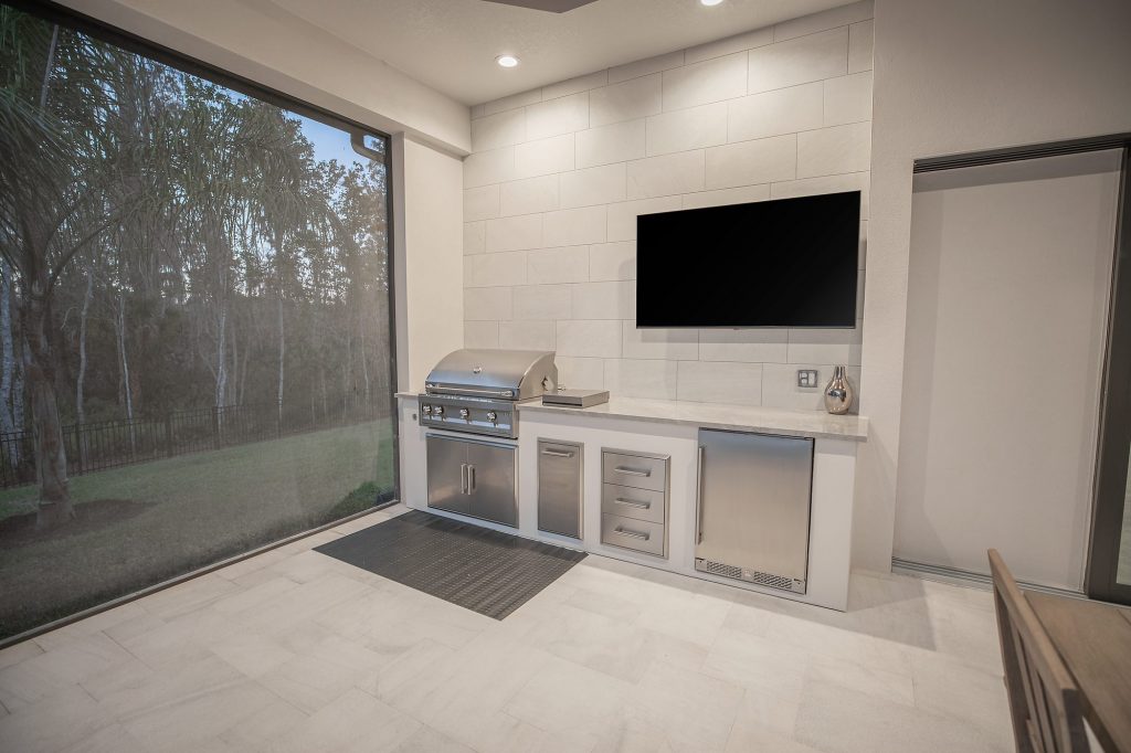 Outdoor Kitchen With Gas Grill Tile Wall and TV WEB