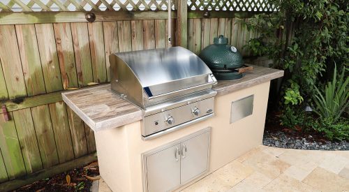 outdoor kitchen with dcs grill and big green egg